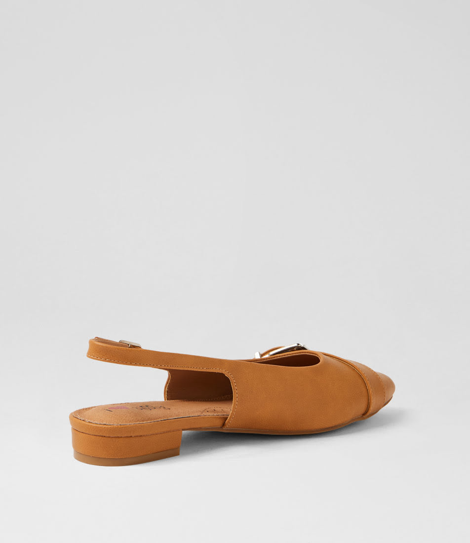 A tan suede slingback flat sandal with a low block heel and a small gold-tone buckle detail on the strap, shown from a side-rear angle against a light gray background.